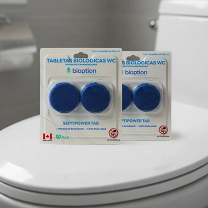 Dos paquetes de tabletas biológicas azules para inodoro Trini Vital Store sobre la tapa de un WC blanco.